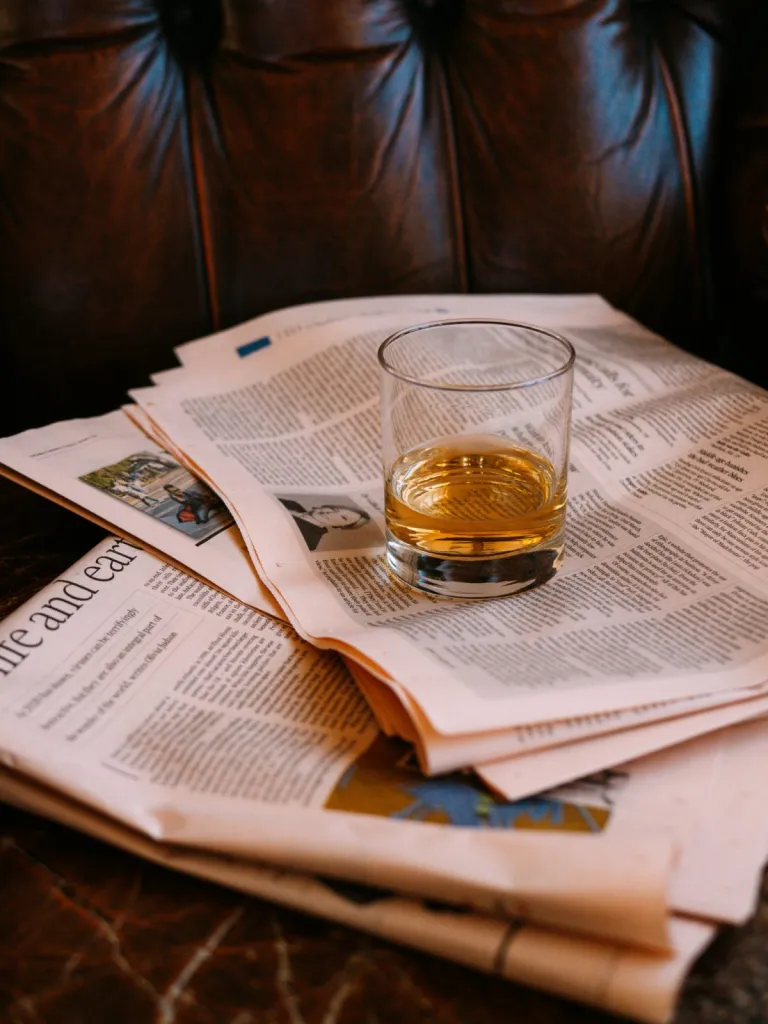 whisky glass on a leather armchair