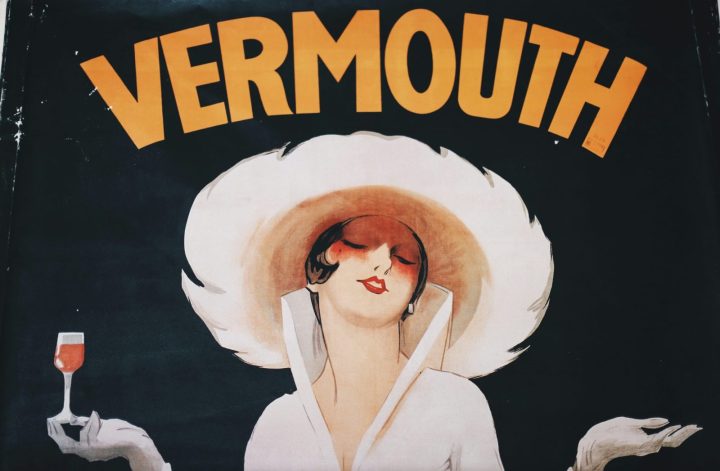 old style vermouth posted with a woman holding a glass