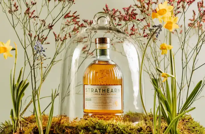 Strathearn batch 2 whisky bottle with flowers around it
