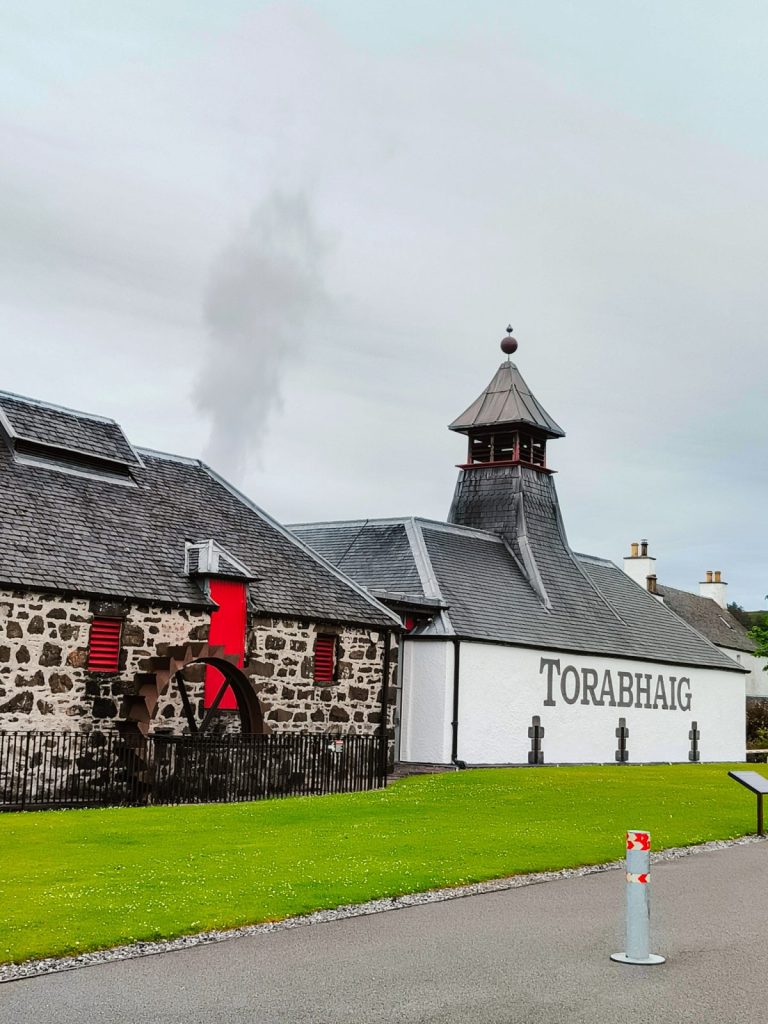 Torabhaig distillery from outside with smoke coming from the still house