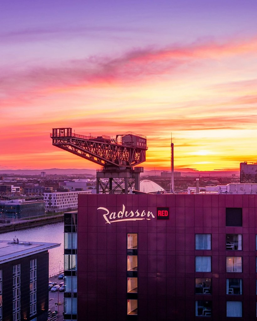 Sunset view of Glasgow with Finnieston crane and Radisson red hotel