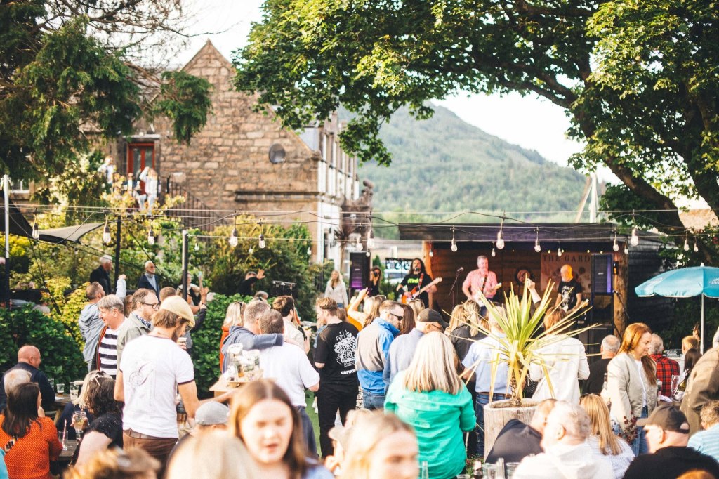 People in the beer garden of The George Hotel with live music