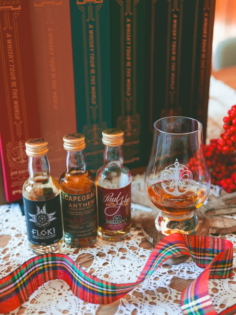 A Whisky Tour of the World second edition with three miniatures next to a whisky glass