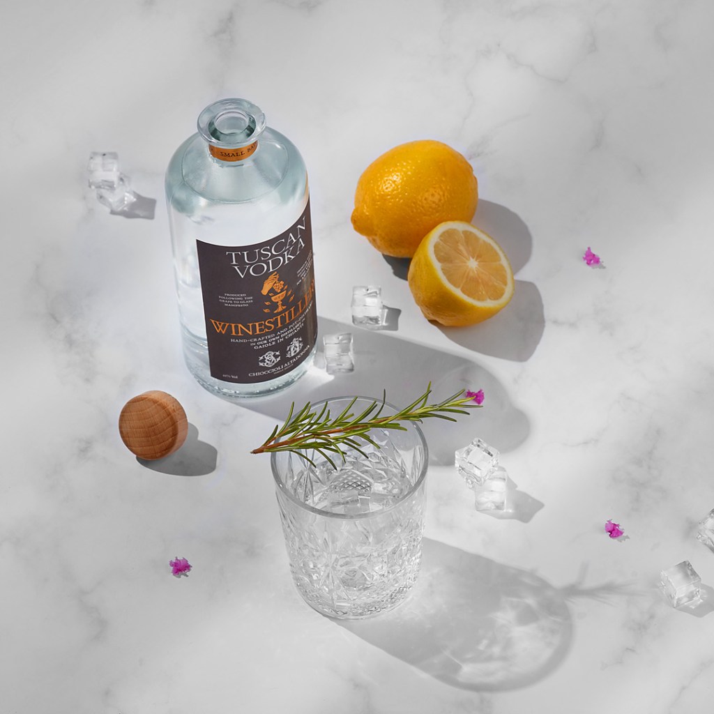 Tuscan vodka bottle and a tumbler with ice and rosemary